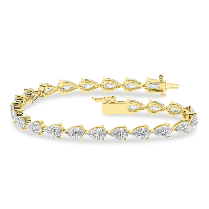 Stack of 14KT white gold pear diamond tennis bracelets with total carat weights of 5ctw 7ctw and 10ctw